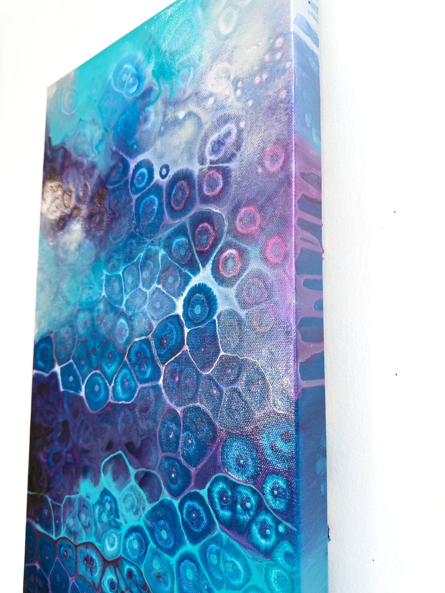 Abstract art piece with blue and purple patterns on a white background