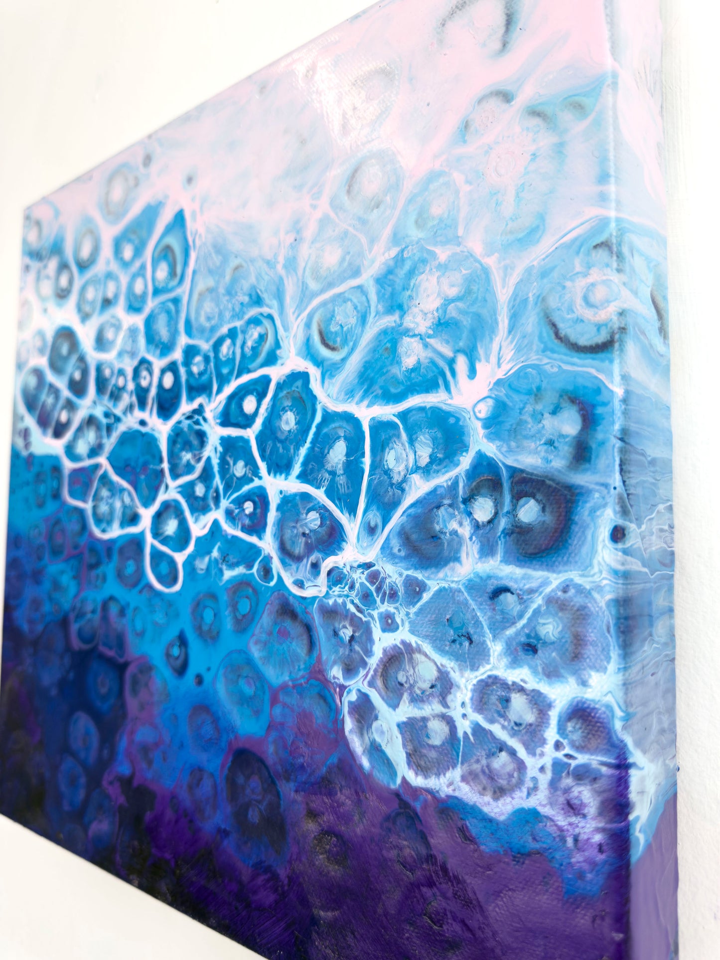 Abstract art piece with blue and purple patterns on a white background