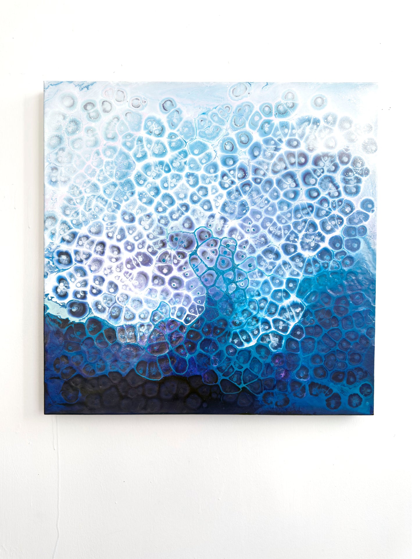 Abstract blue and white patterned painting on a white background