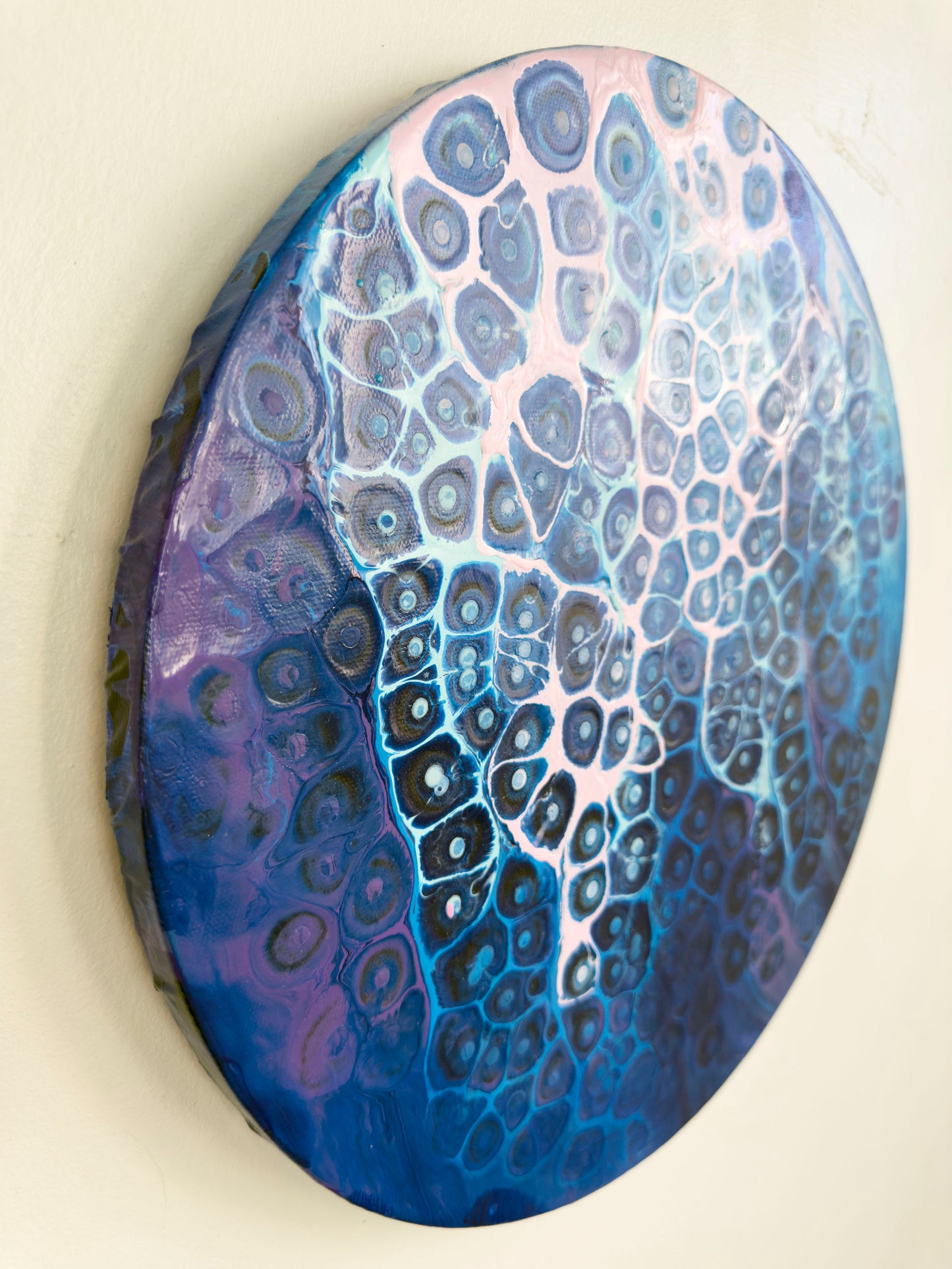 Decorative abstract artwork with a blue and purple pattern on canvas