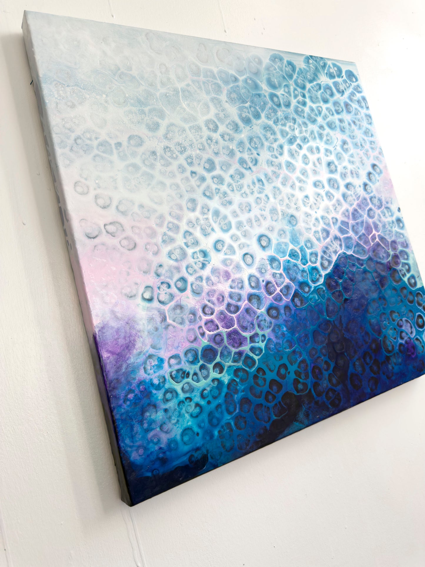 Abstract art piece with blue and purple gradient on a white background