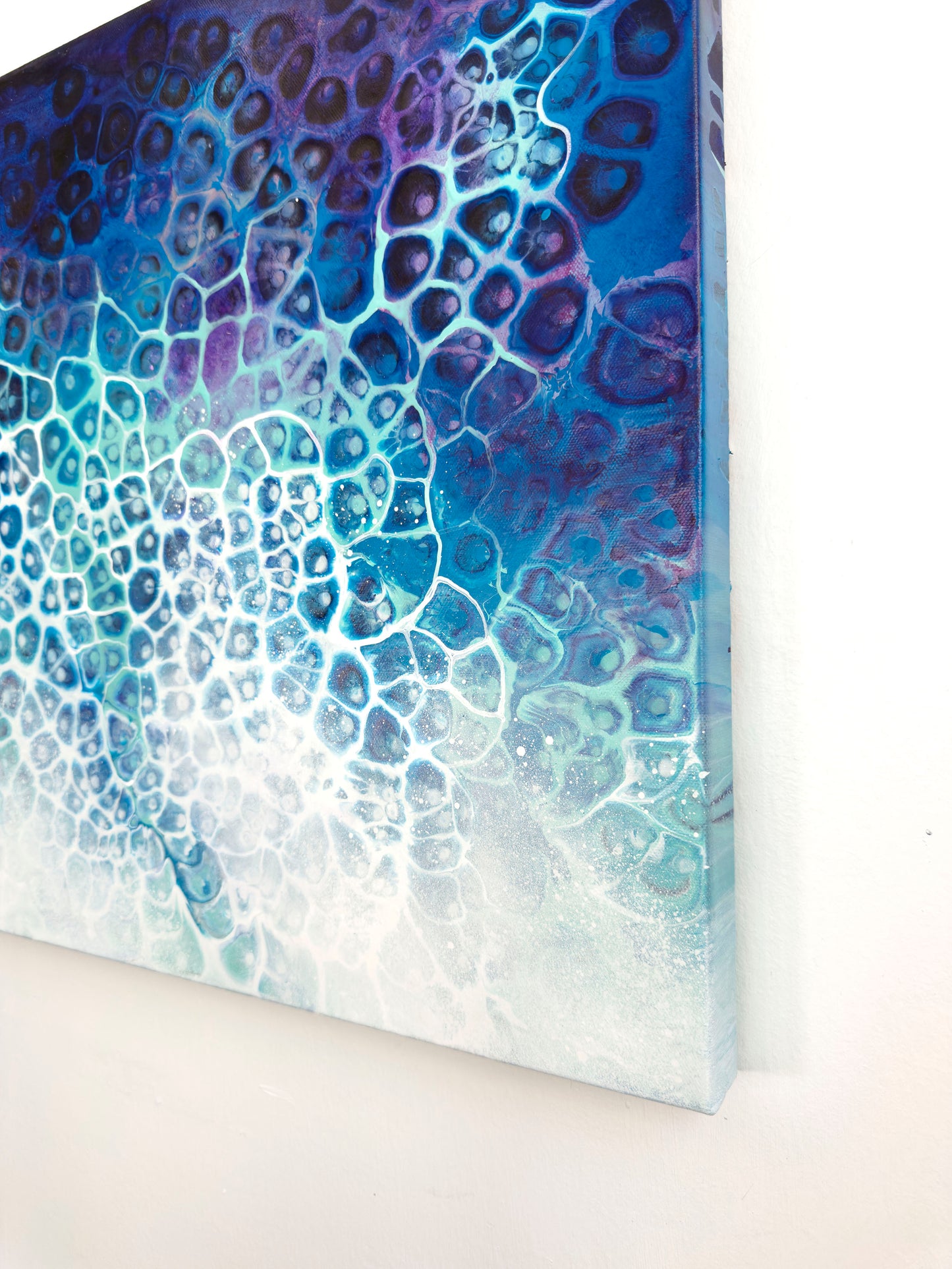 Abstract art piece with blue and purple gradient on a white background