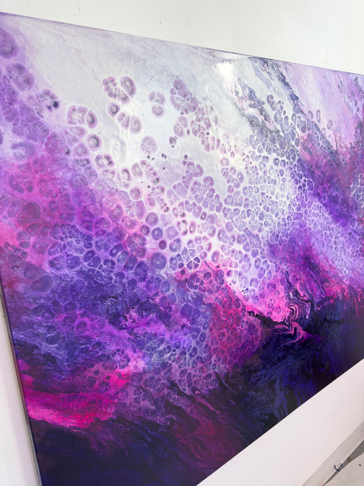 Abstract art piece with purple and pink colors on a white background