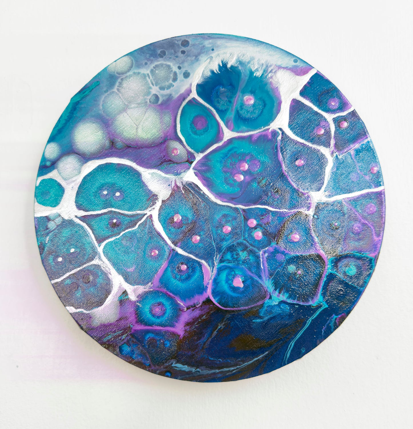 Round abstract art with a blue and purple abstract design on a white background