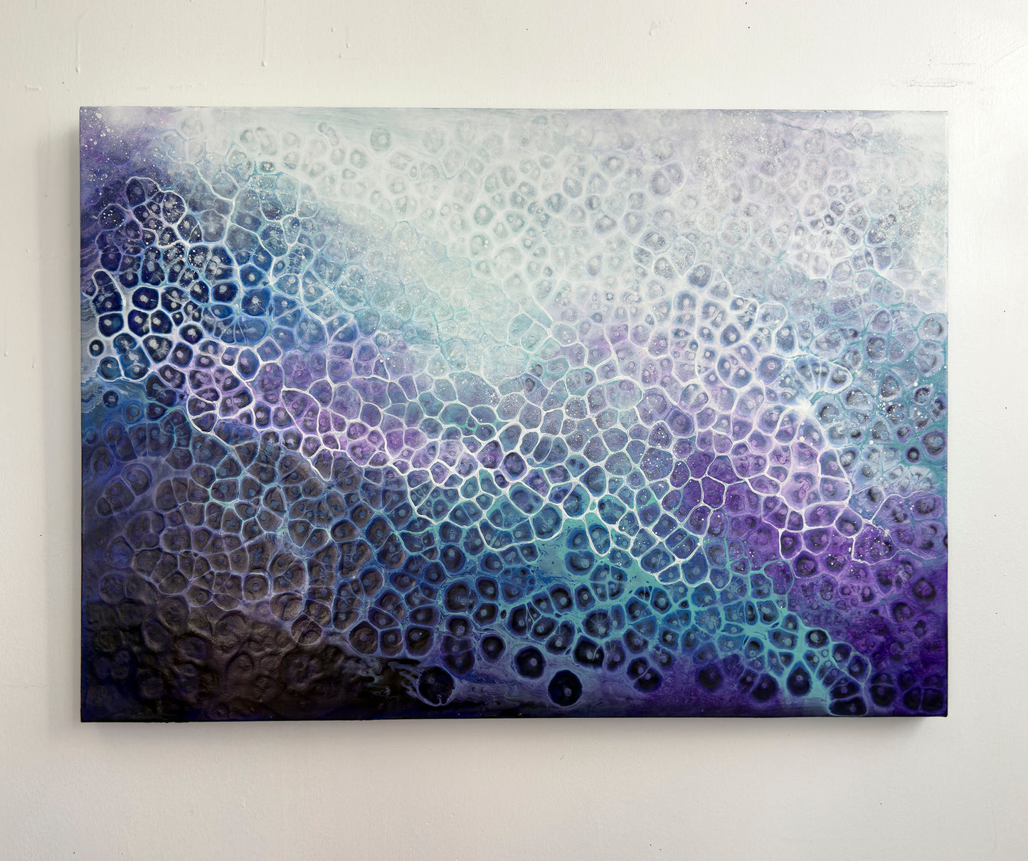 Abstract art piece with a gradient of blue and purple on a white background