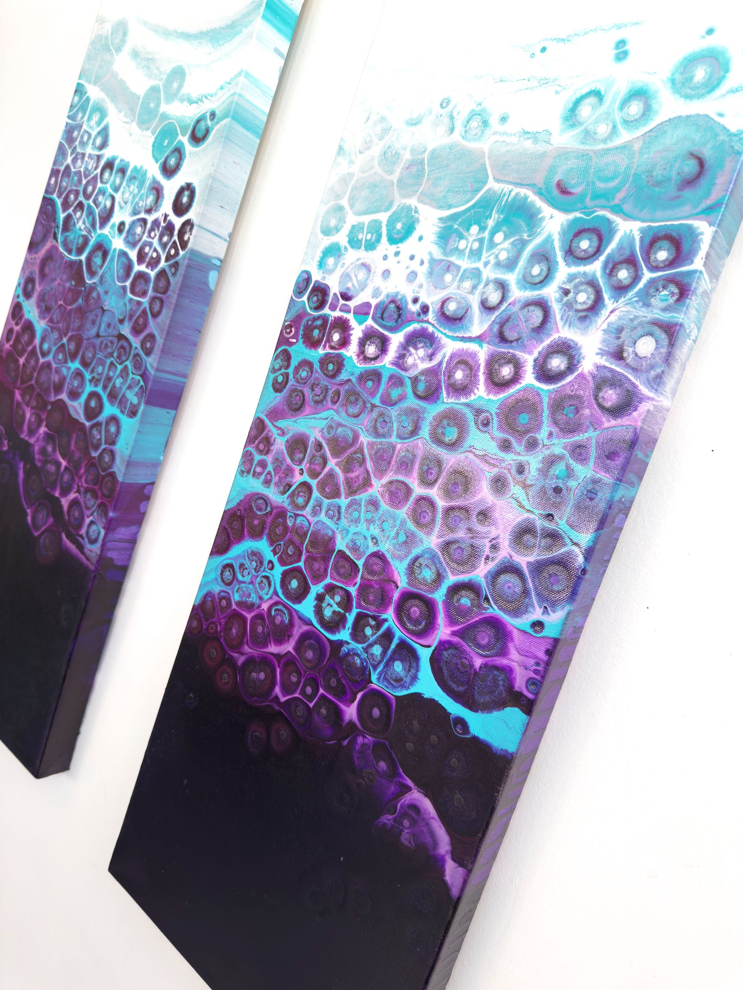Two abstract art pieces with a gradient of purple and blue on a white background