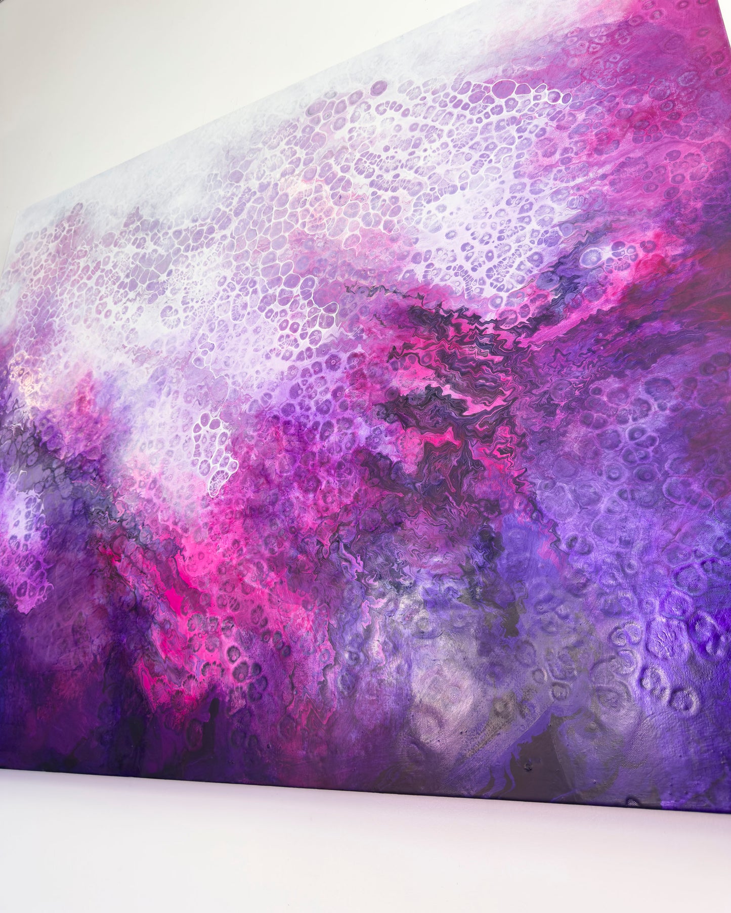 Abstract art piece with purple and pink colors on a white background