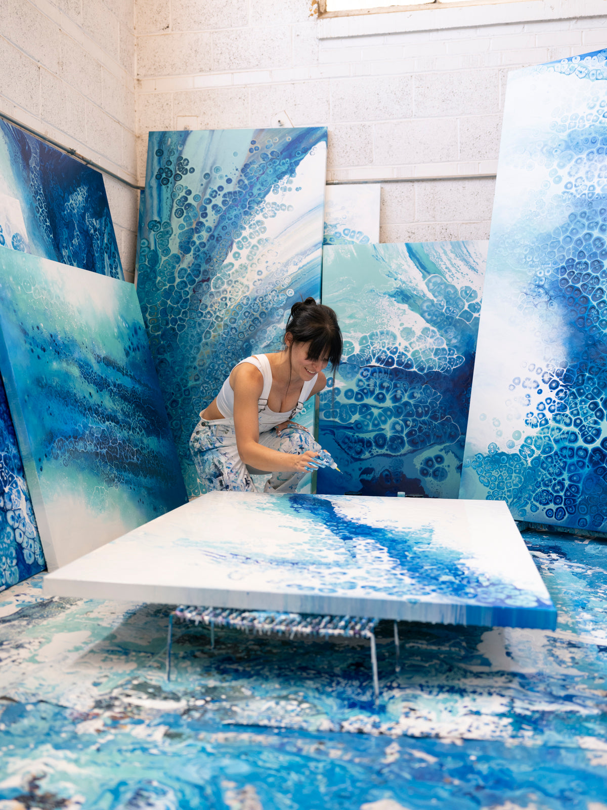 abstract fluid artist painting blue ocean abstract fluid artwork in art studio